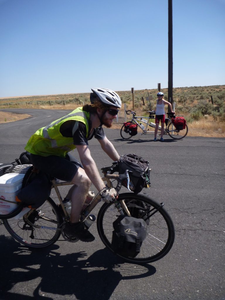 Michael Altfield rides a bicycle on a highway in Washington State, USA